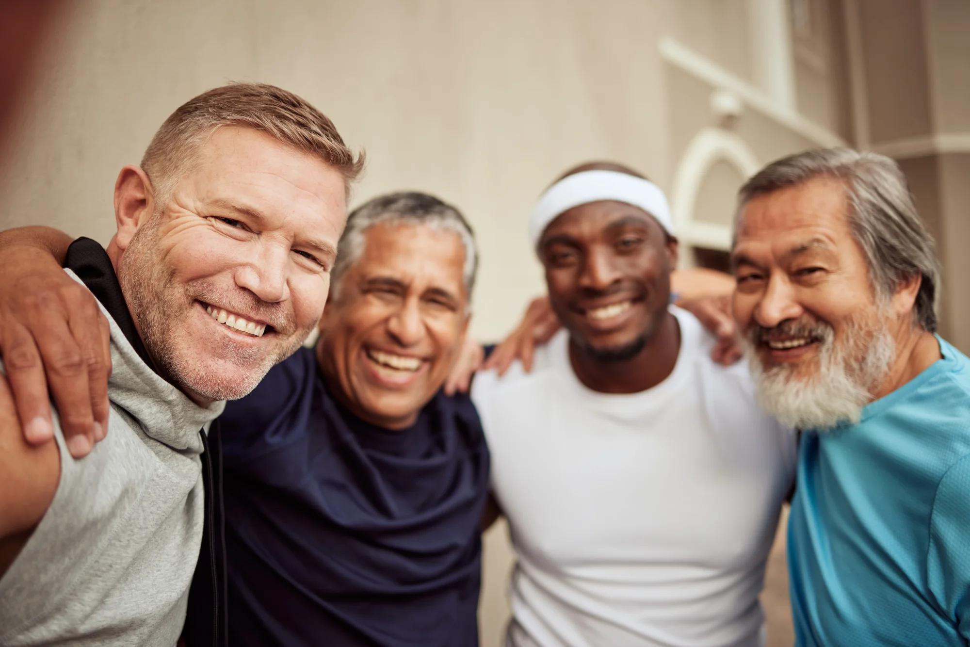 Diverse group of men smiling after fitness activity