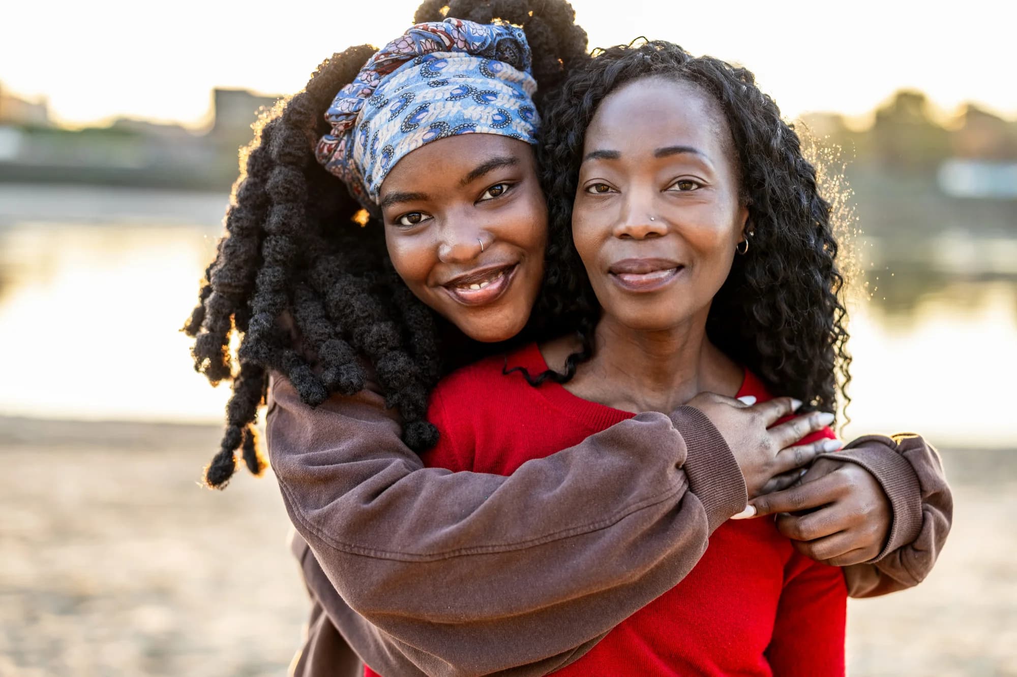 Mother and daughter embracing at the beach