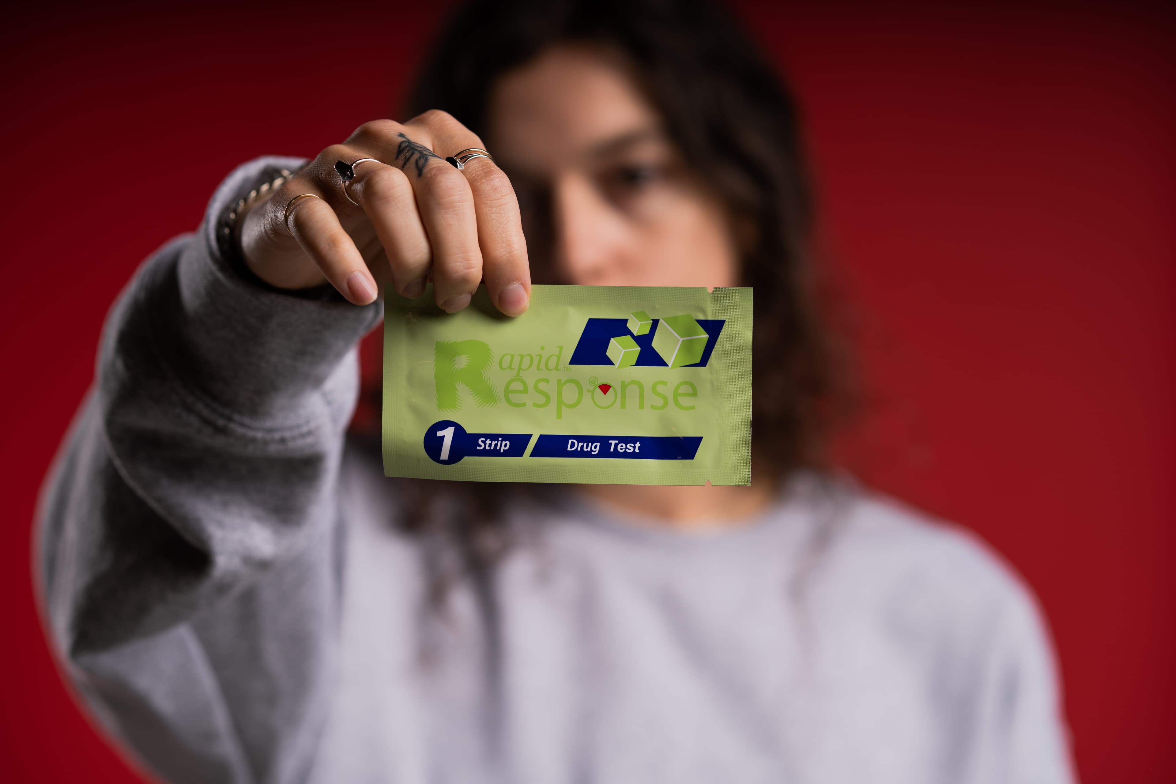 Person holding rapid response test strip