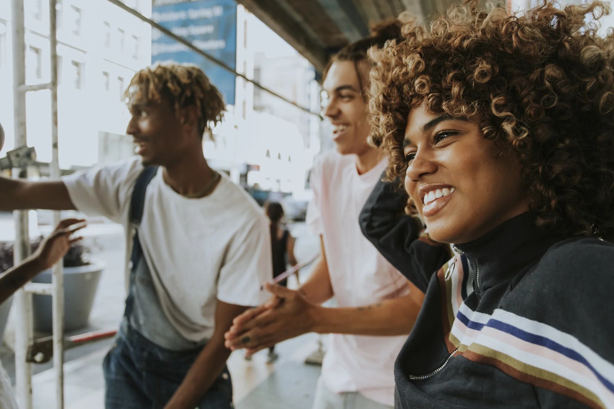 Young friends smiling together on an urban street